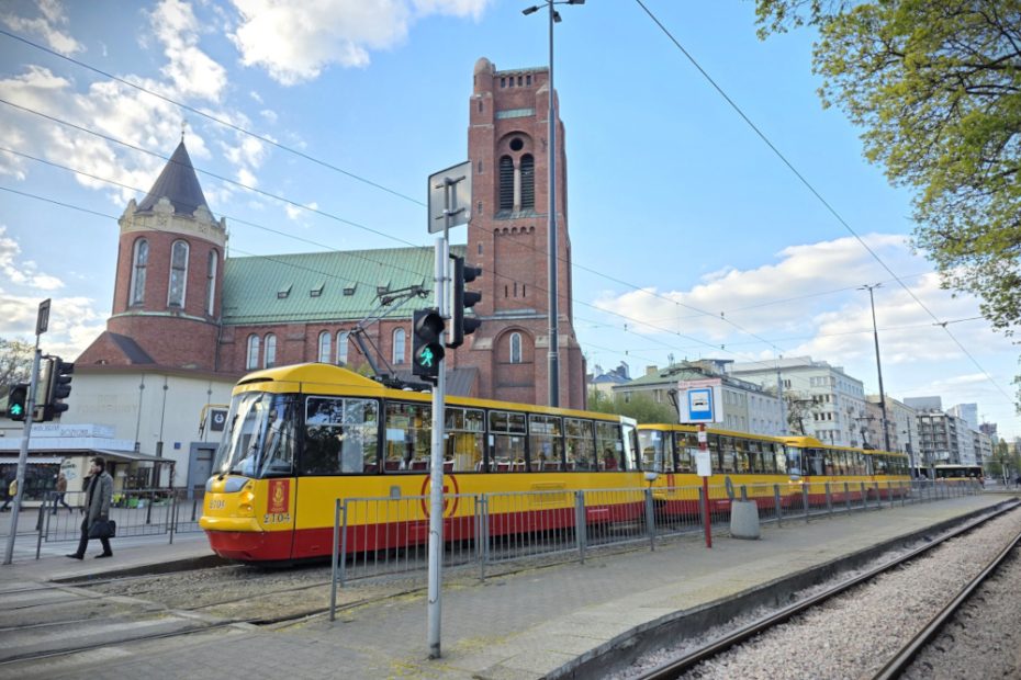 Zdjęcie przedstawia tramwaj na przystanku tramwajowym na Placu Narutowicza. W tle widoczny kościół.
